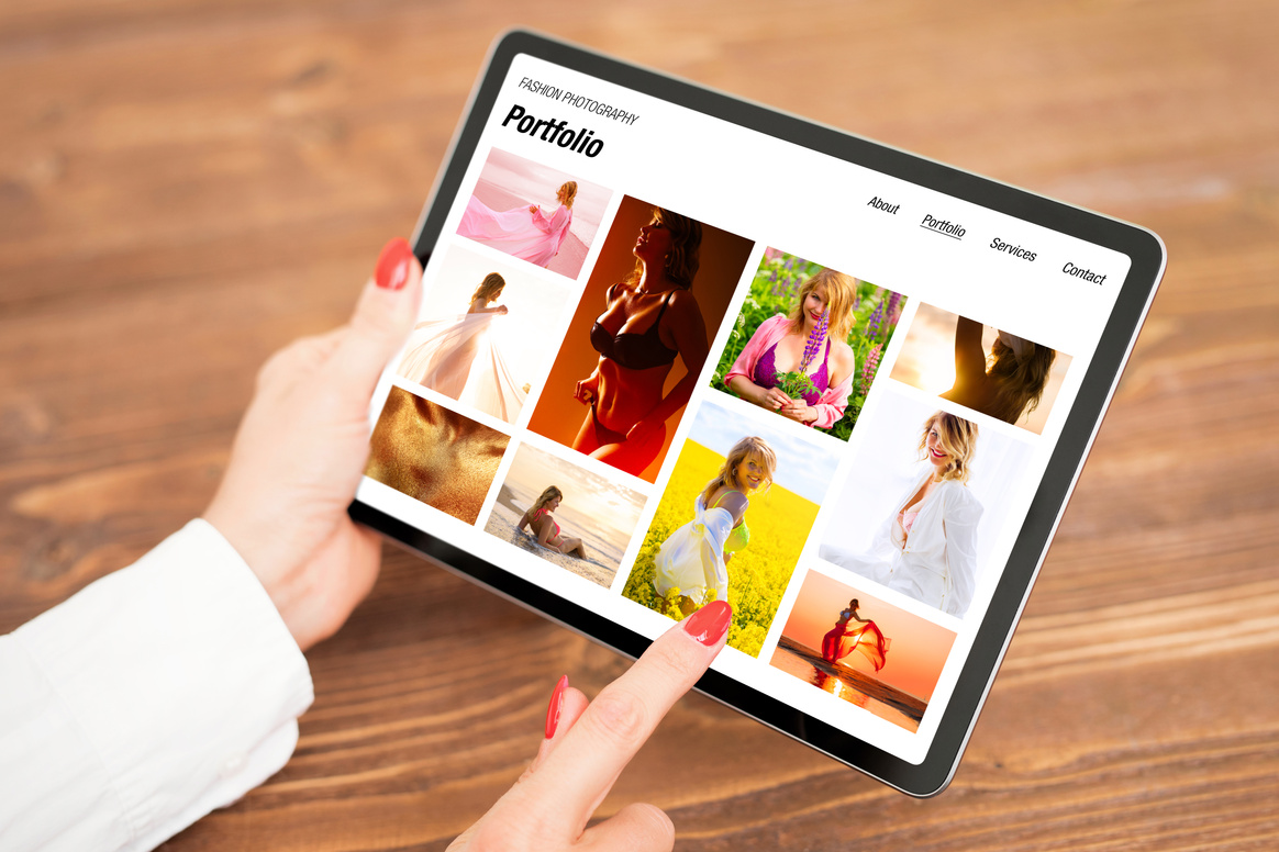 Woman Looking at Fashion Photography Portfolio on Tablet